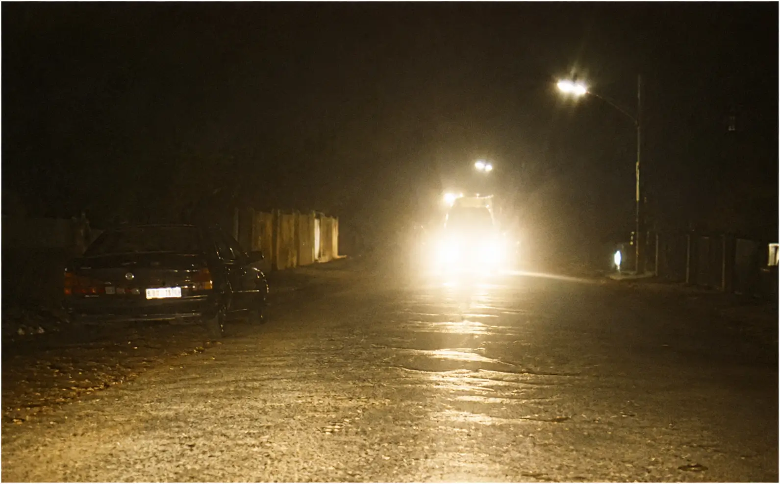 Road at night with bright headlights dazzling