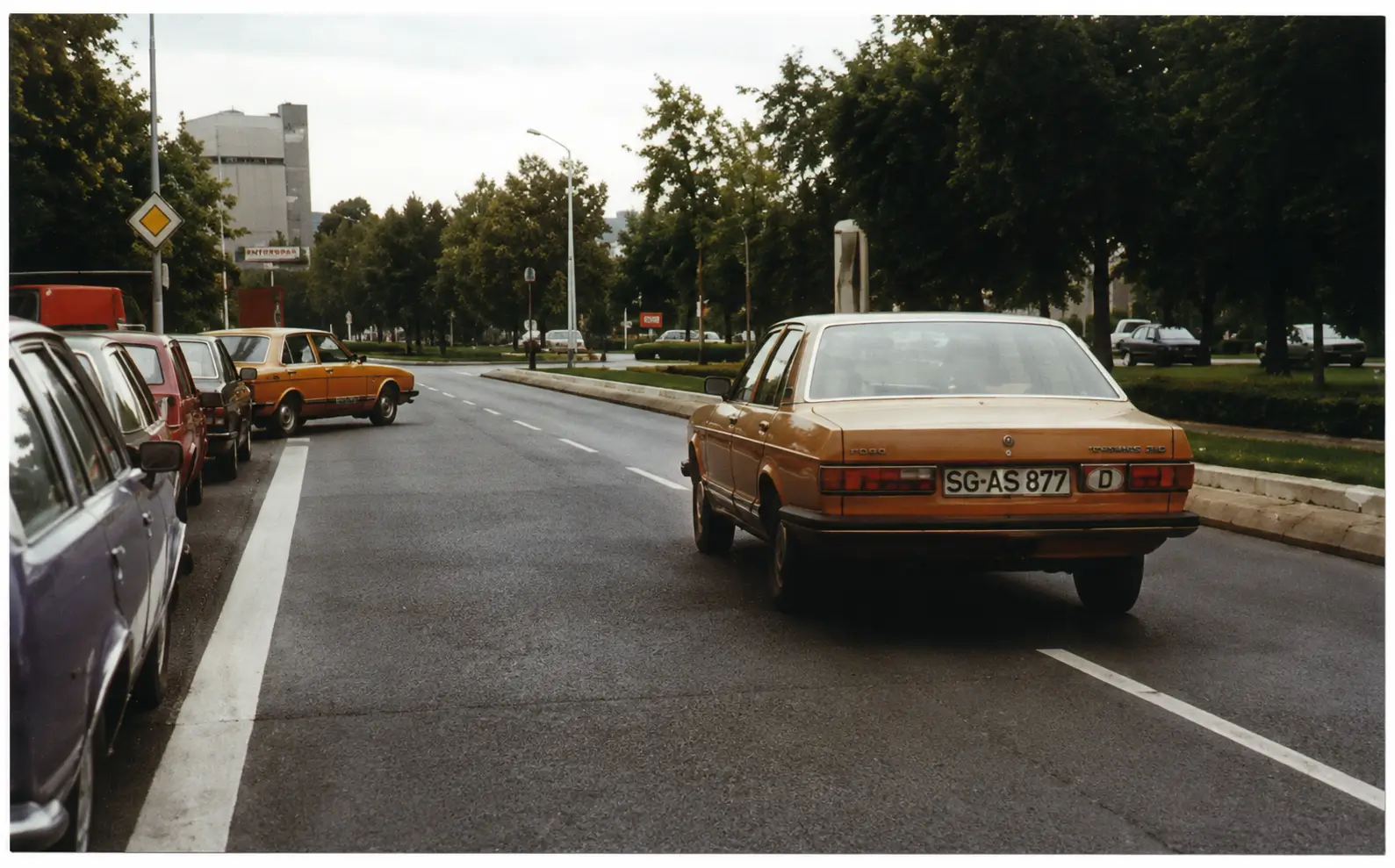 Car reversing into parking space on road