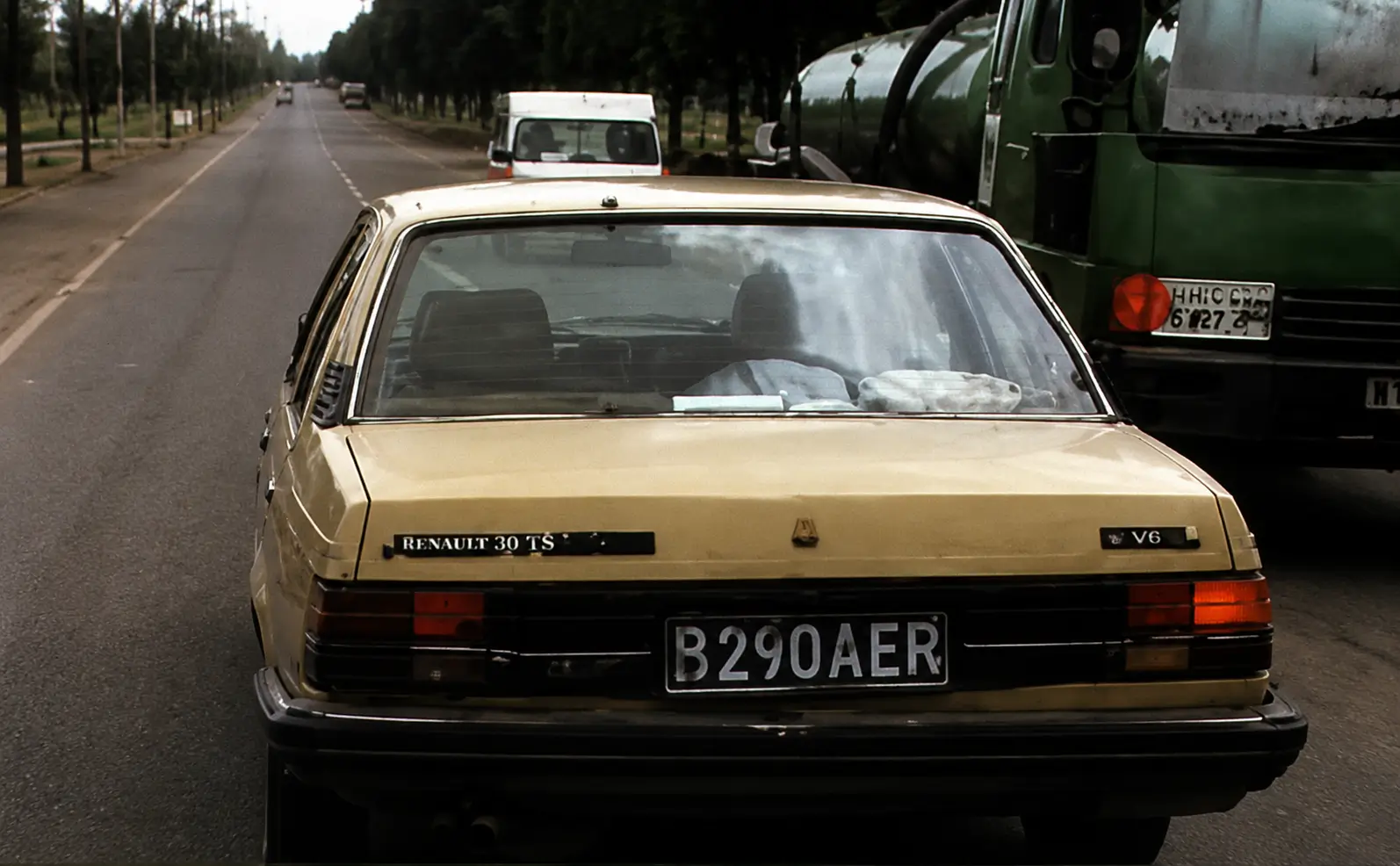Car approaching roadworks with oncoming vehicle