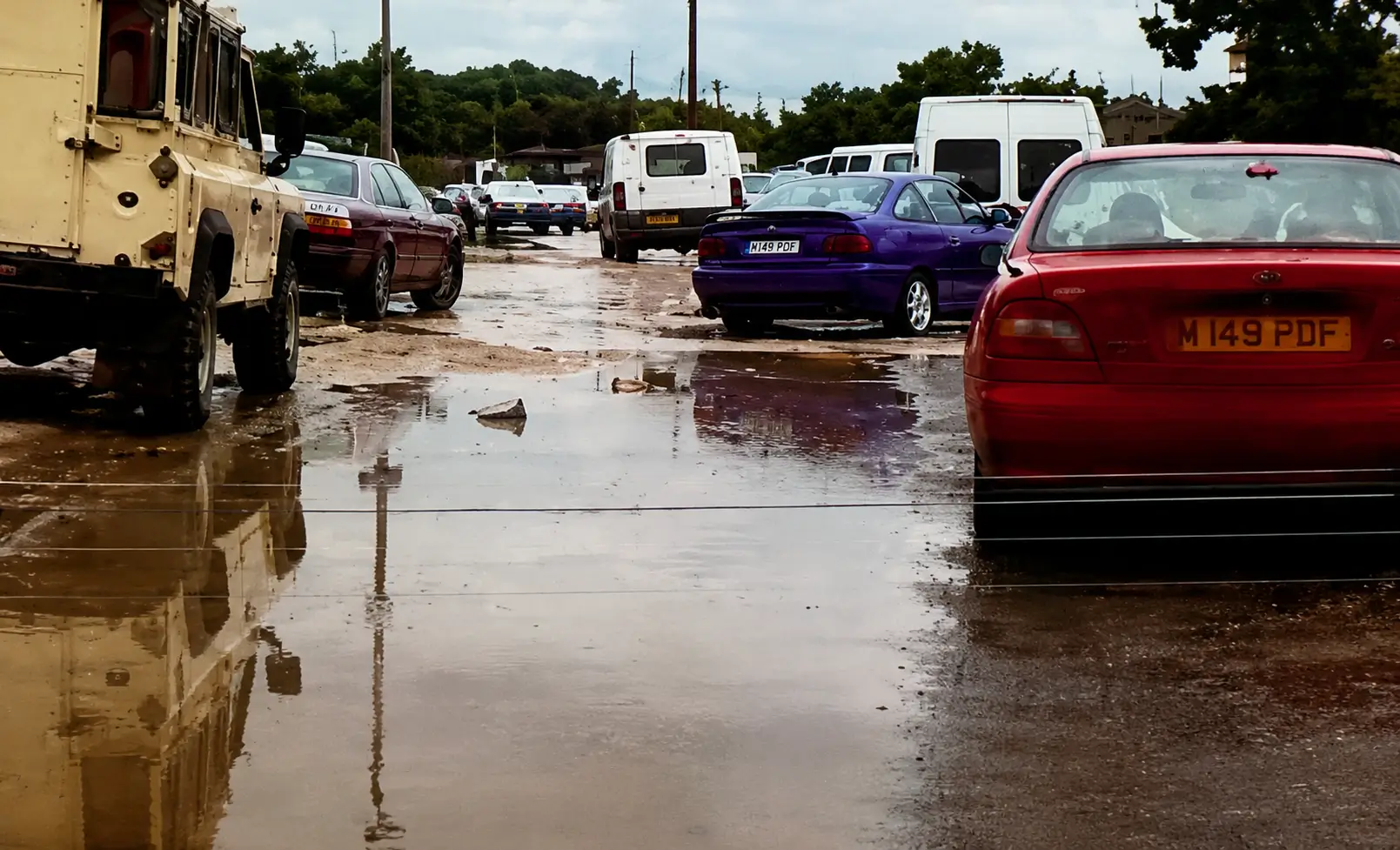 Wet road with puddles and traffic
