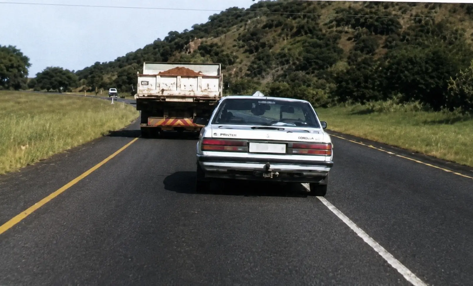 Car overtaking truck on country road