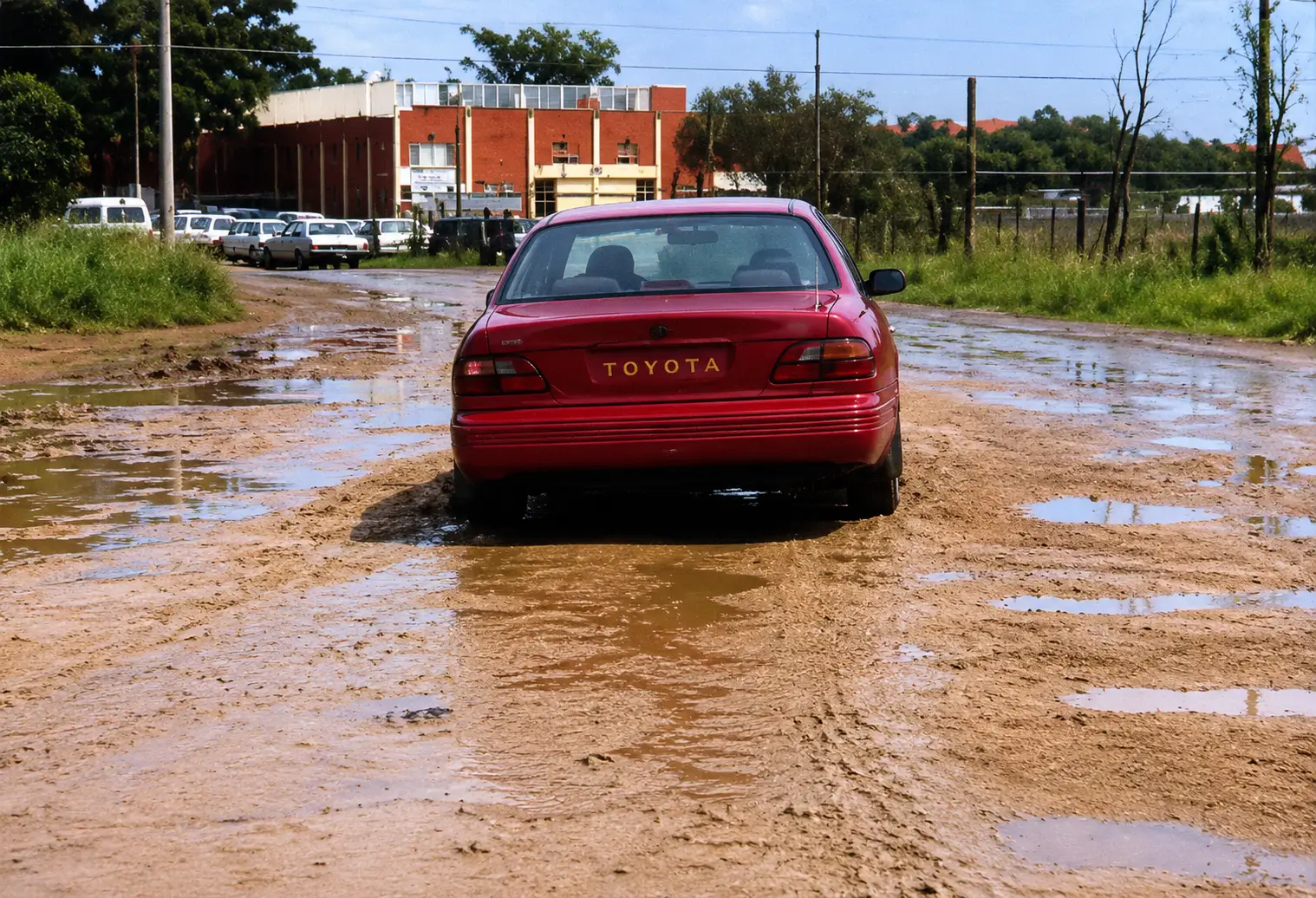 Red car on wet/slushy road