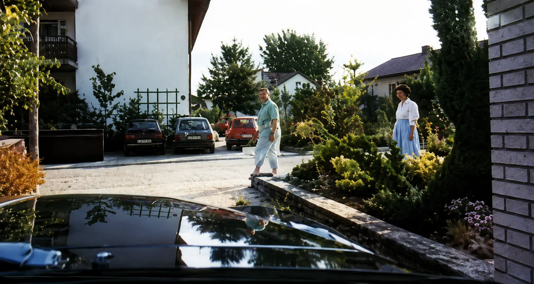 Car leaving driveway, pedestrians on pavement
