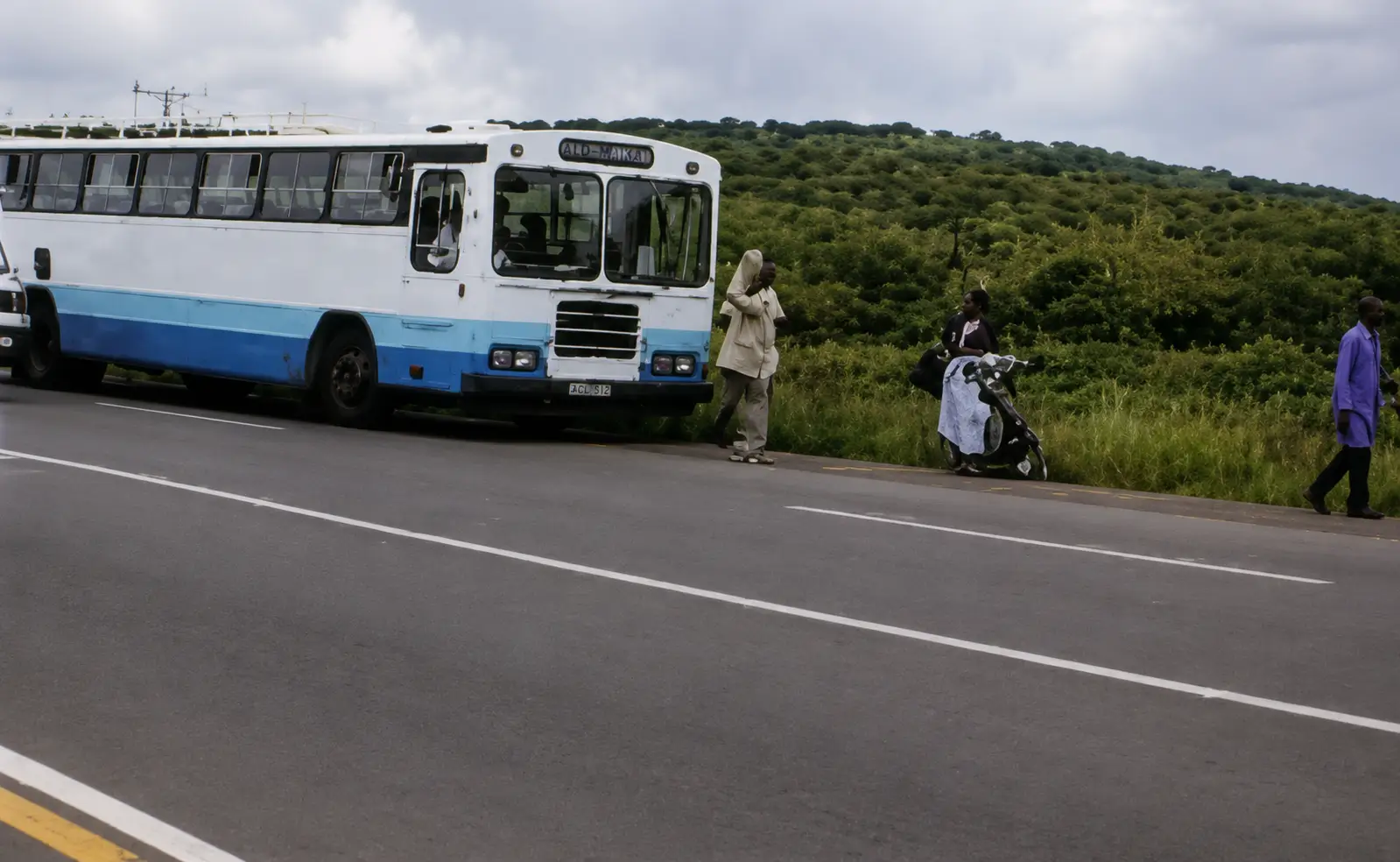 Photo of bus stopped with people around