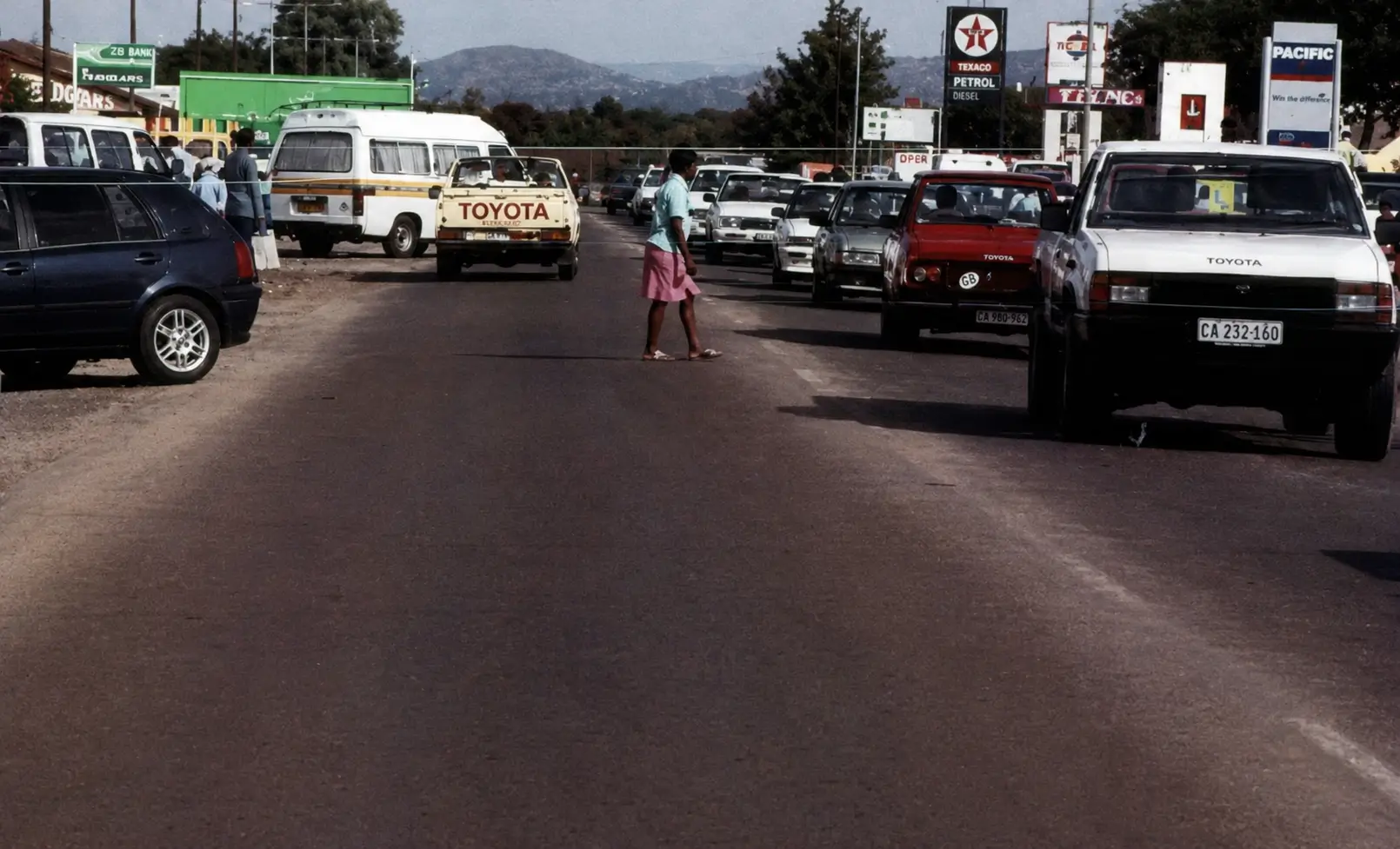 Photo of road with pedestrian crossing between cars