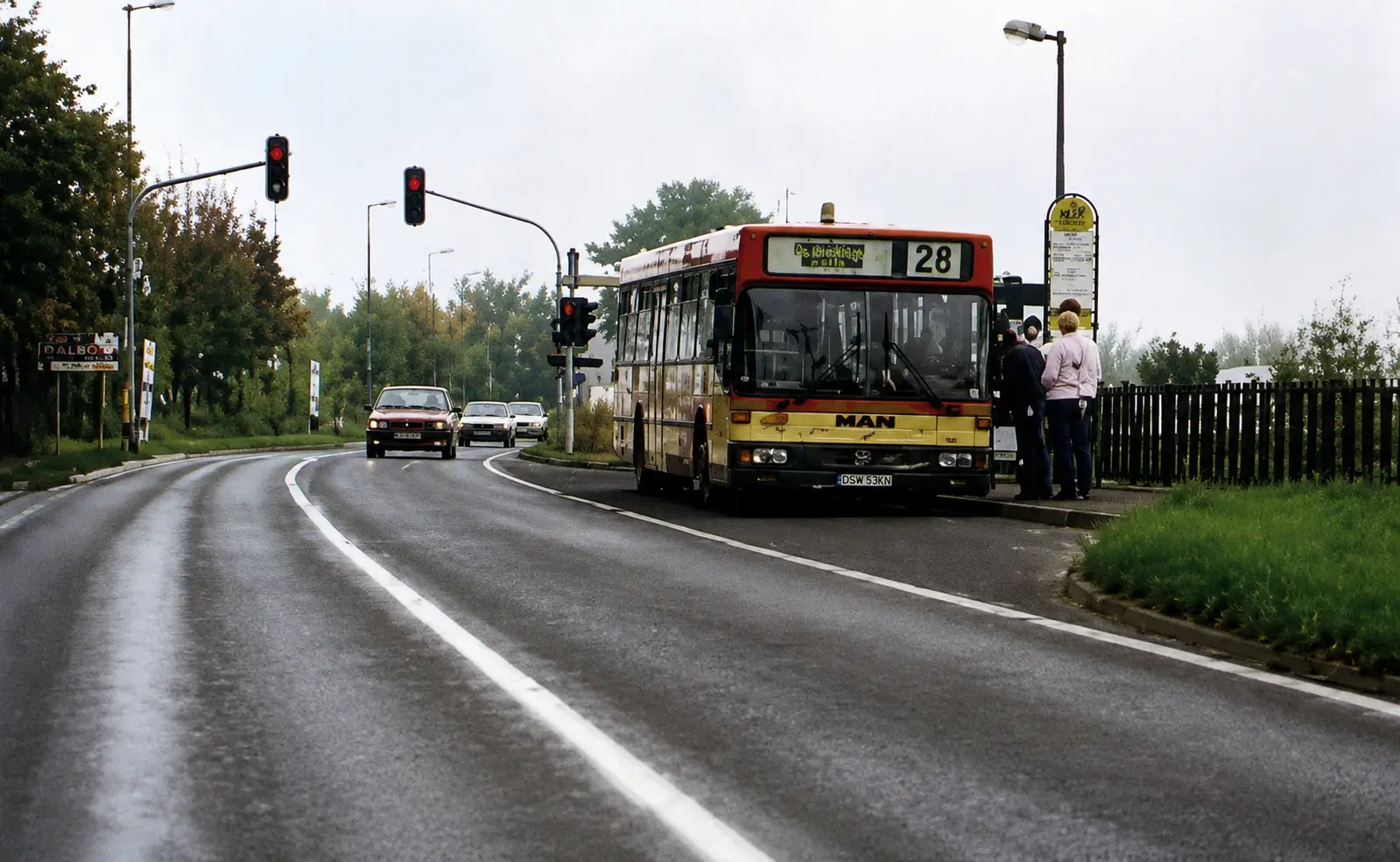 Photo of bus stopped at bus stop on road