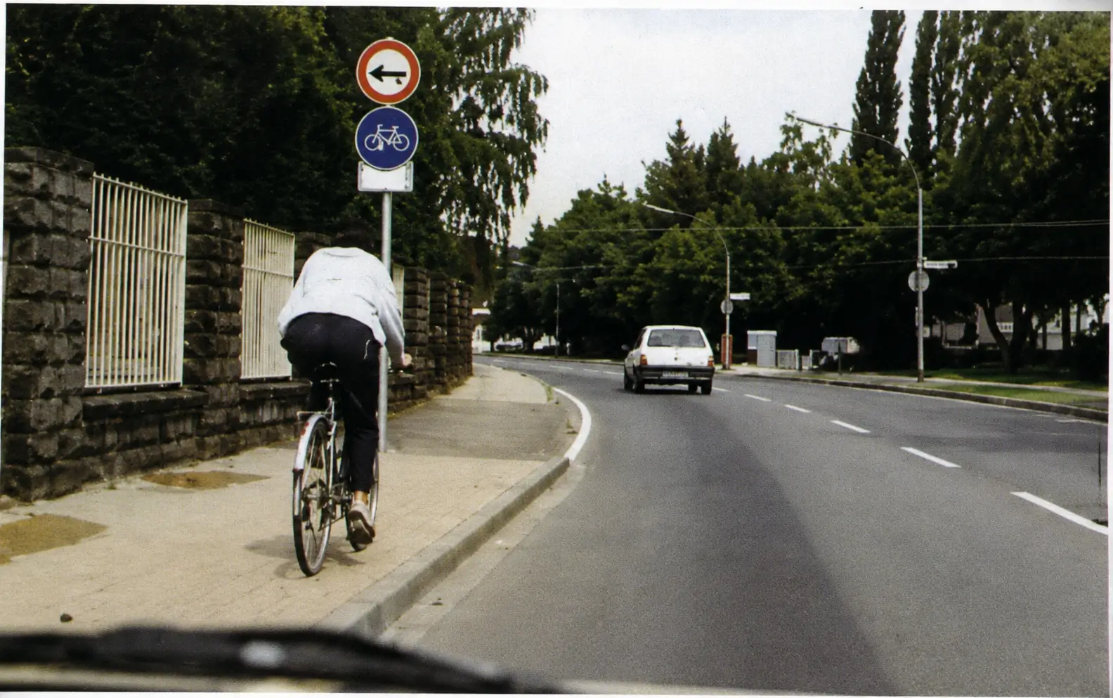 Photo of cyclist on roadside near road