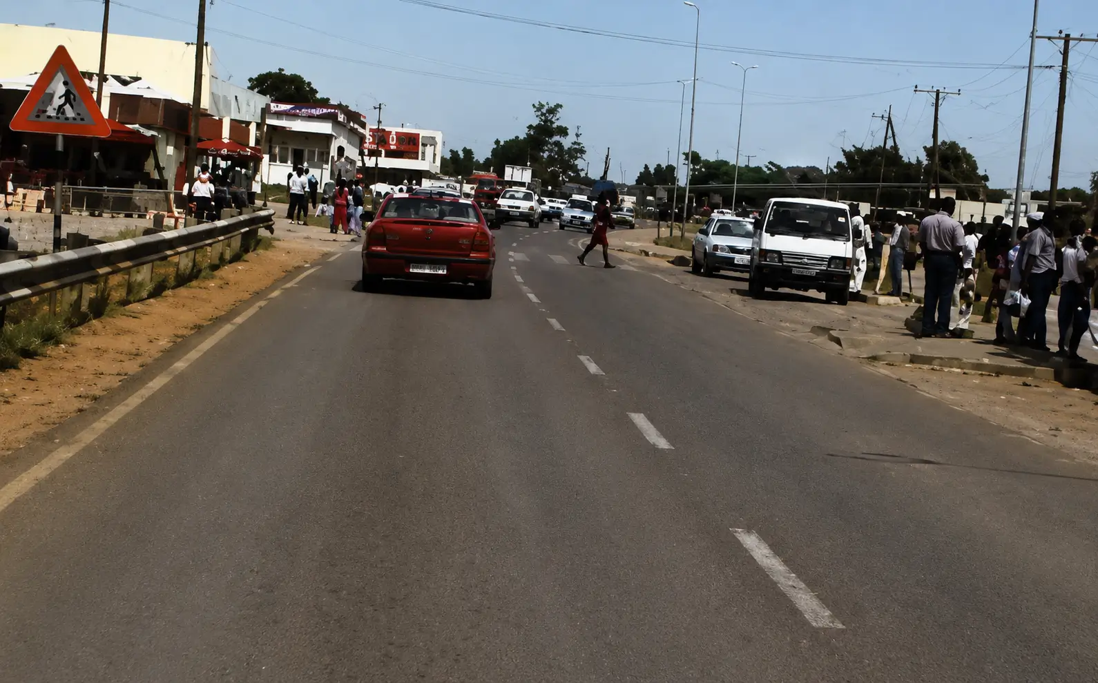 Photo of busy road with pedestrians crossing