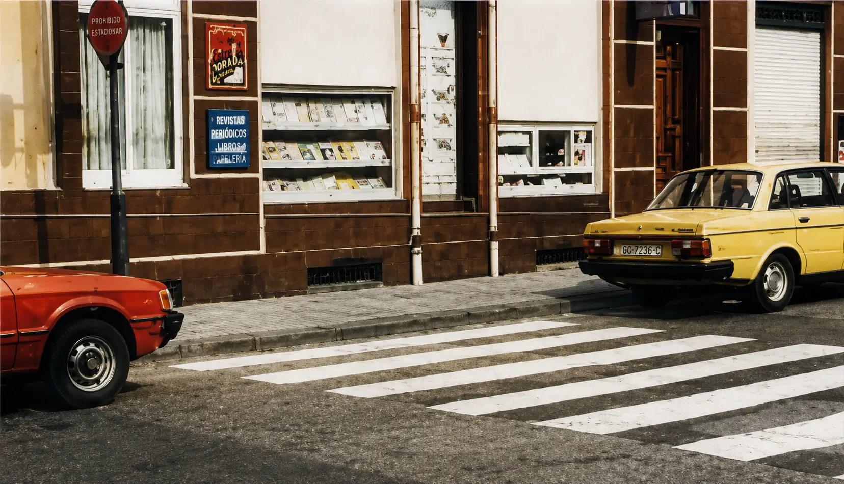 Red car stopped on pedestrian crossing