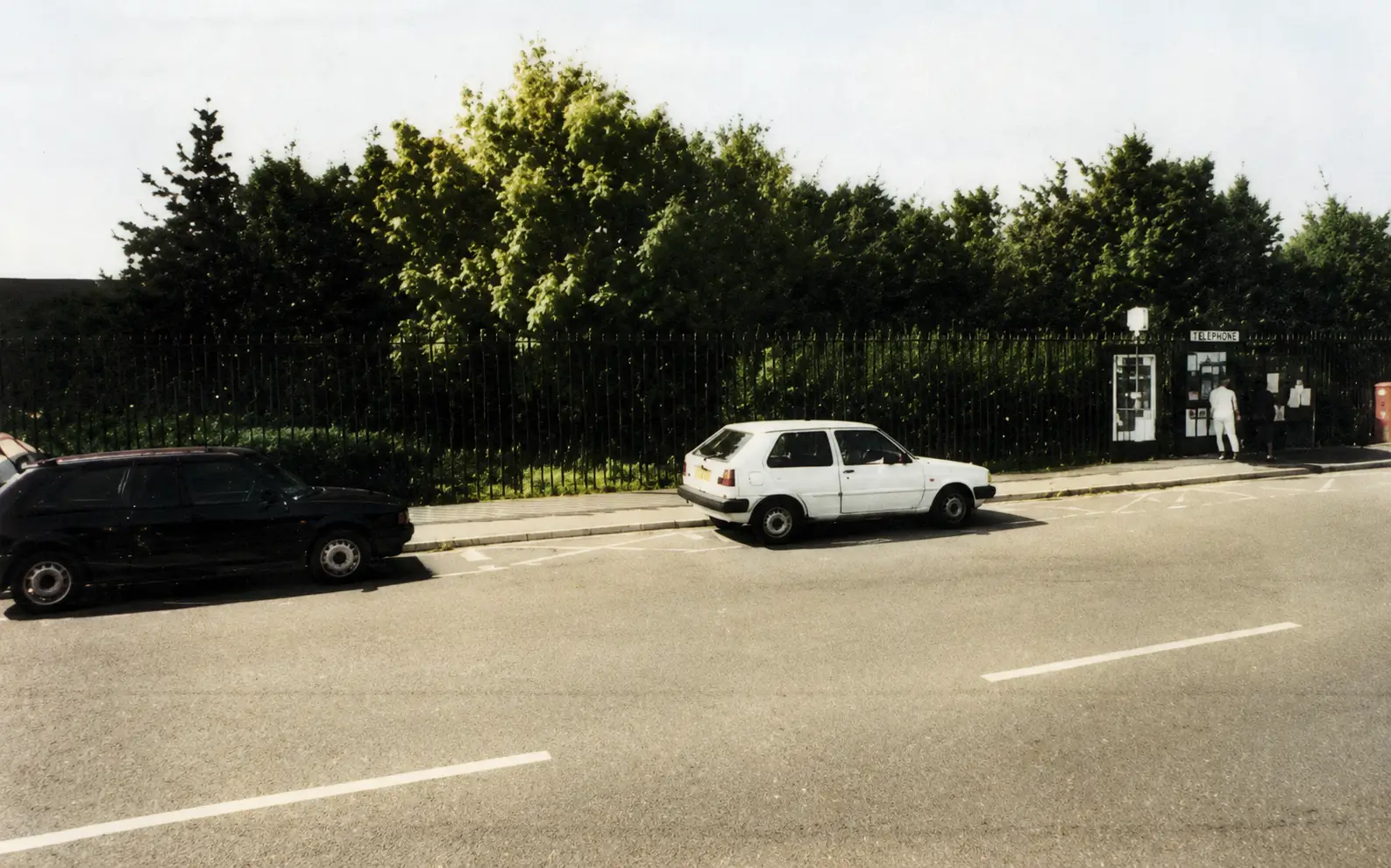 Light-coloured car parked near bus stop