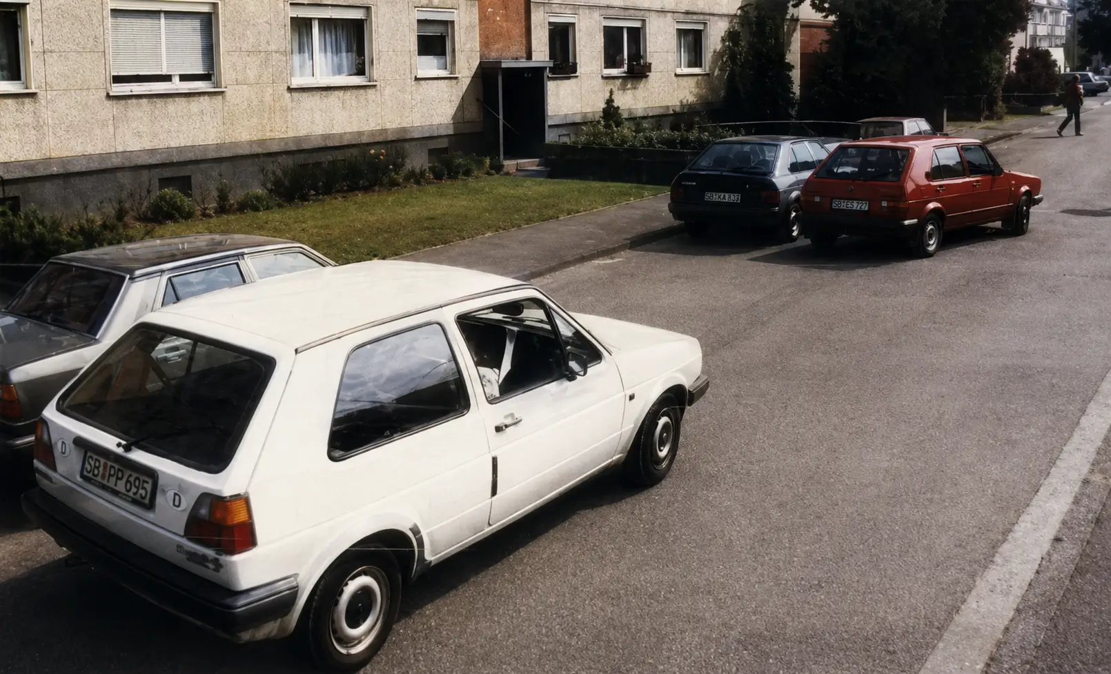 Street with red car and white car
