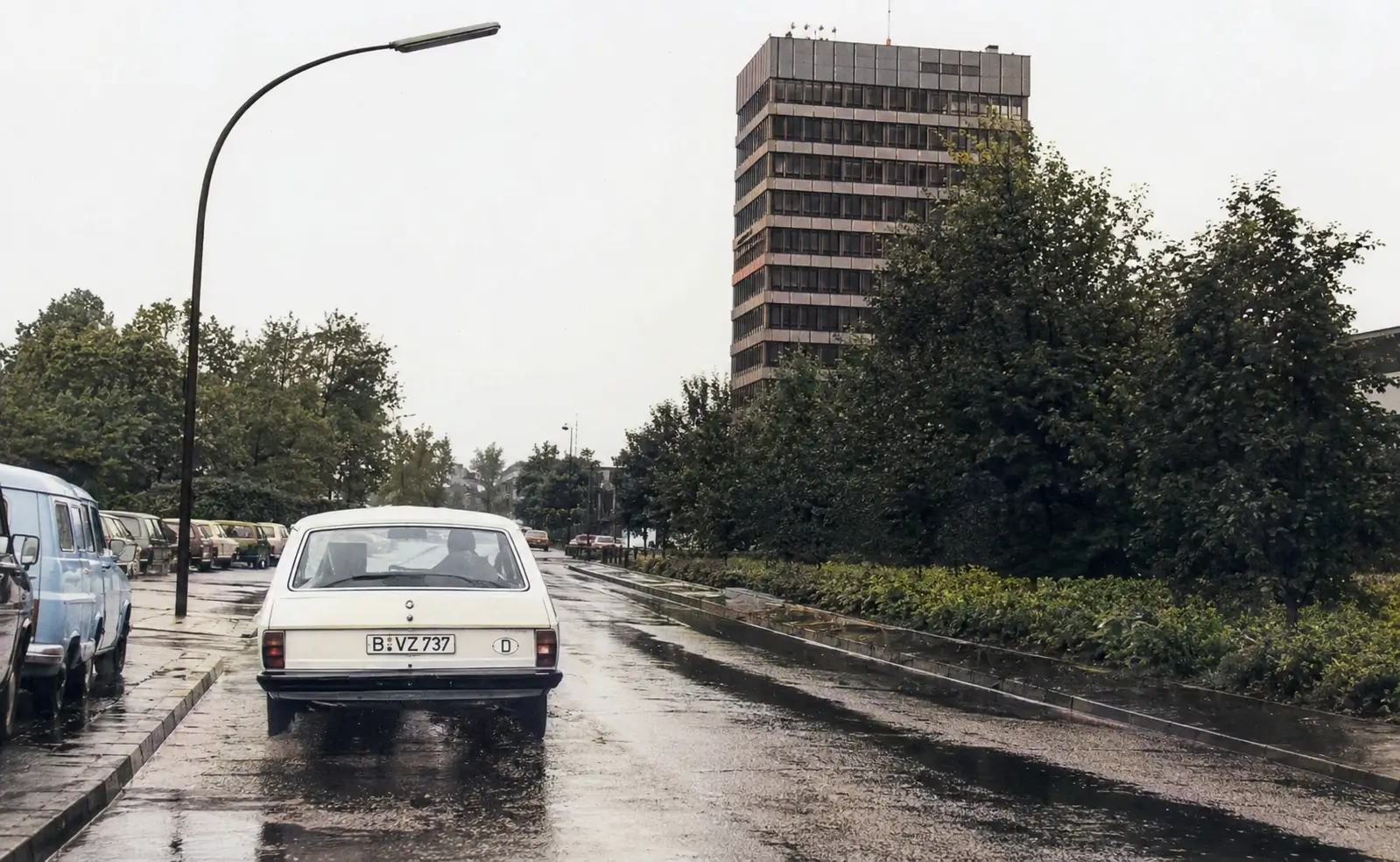 driving on a wet road with cars infront