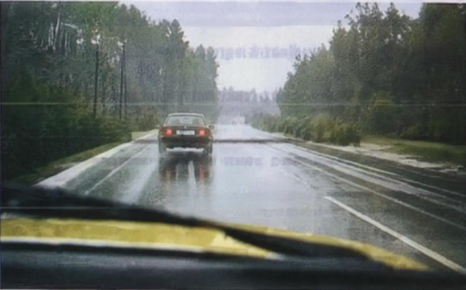 driving behind a car on a wet road