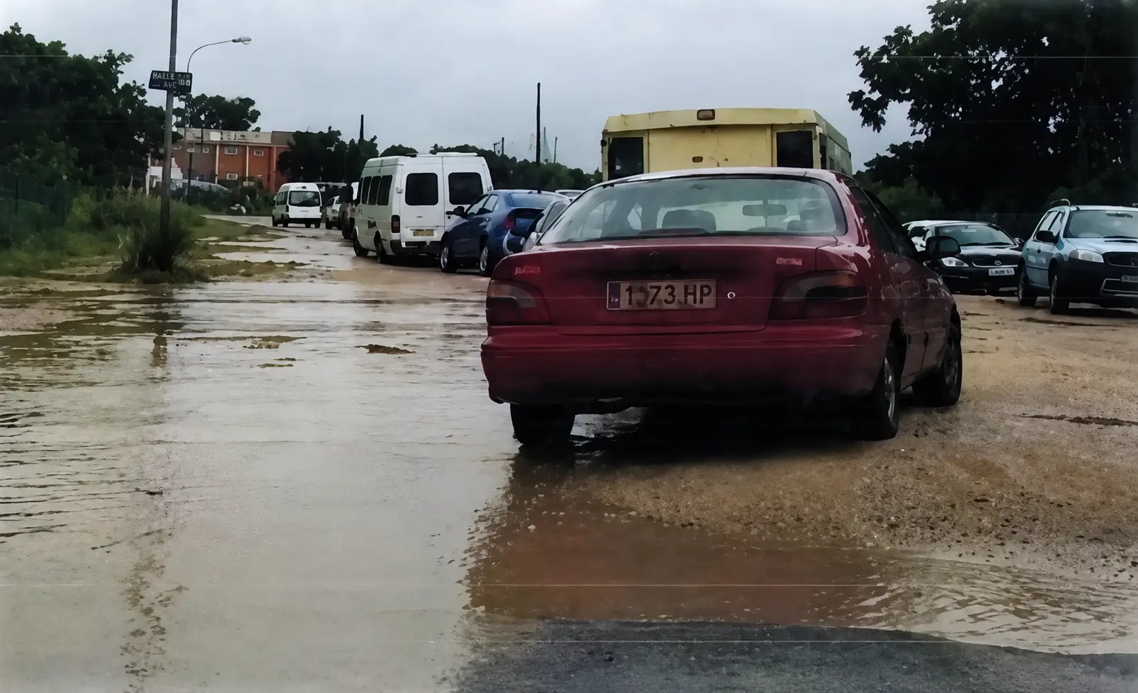 a wet road, wrongly parked car and a bend