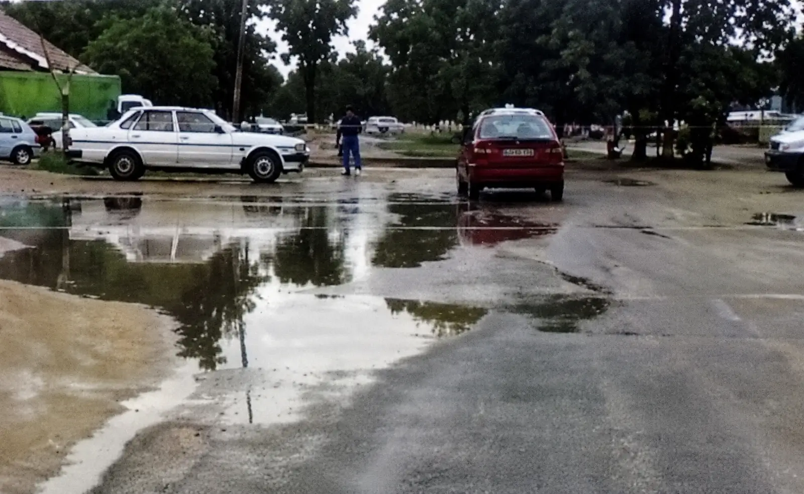 a wet road with a mini joining road on the left