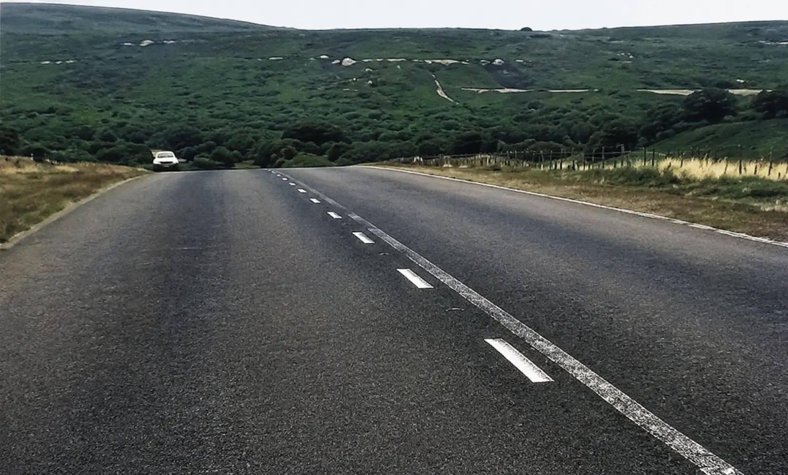 uphill road with a right bend and the other end obscured from view
