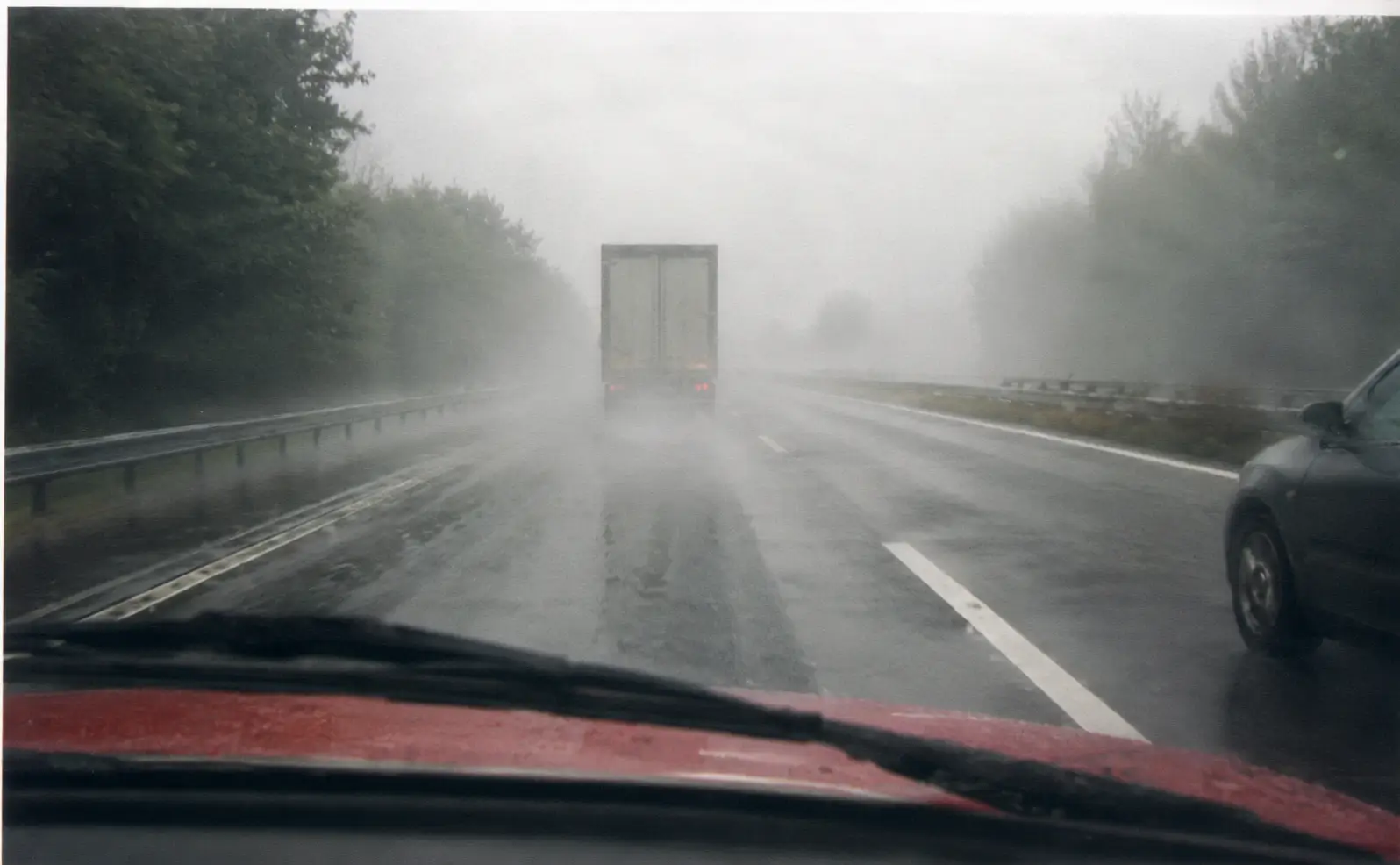 driver's view on a wet road and foggy day