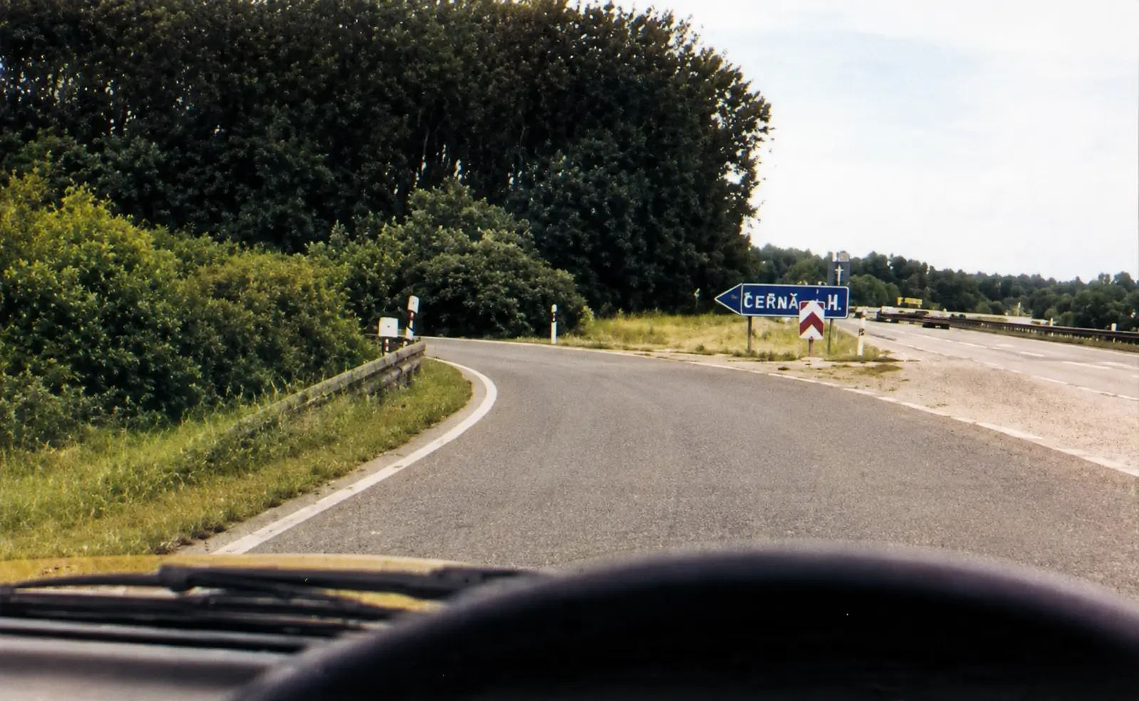 A car approaching a steep bend with no clear view